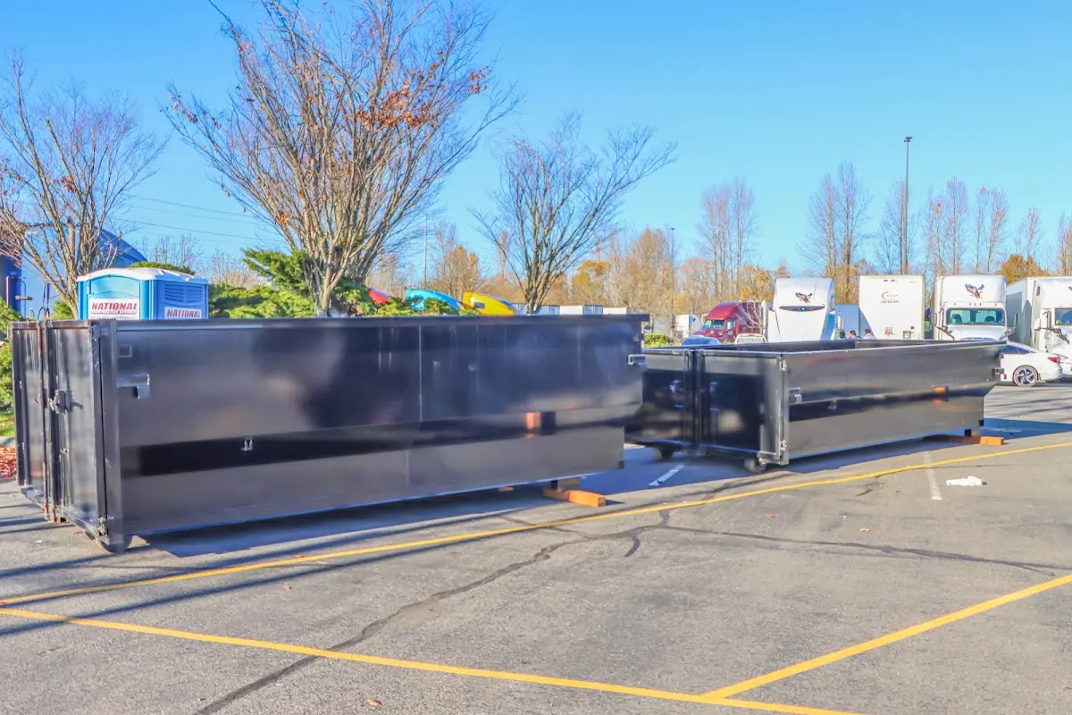Professional dumpster rental service with roll-off container on residential driveway in Acushnet